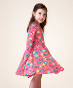 A child wearing the Frugi Sofia Pink fun flowers print skater dress.