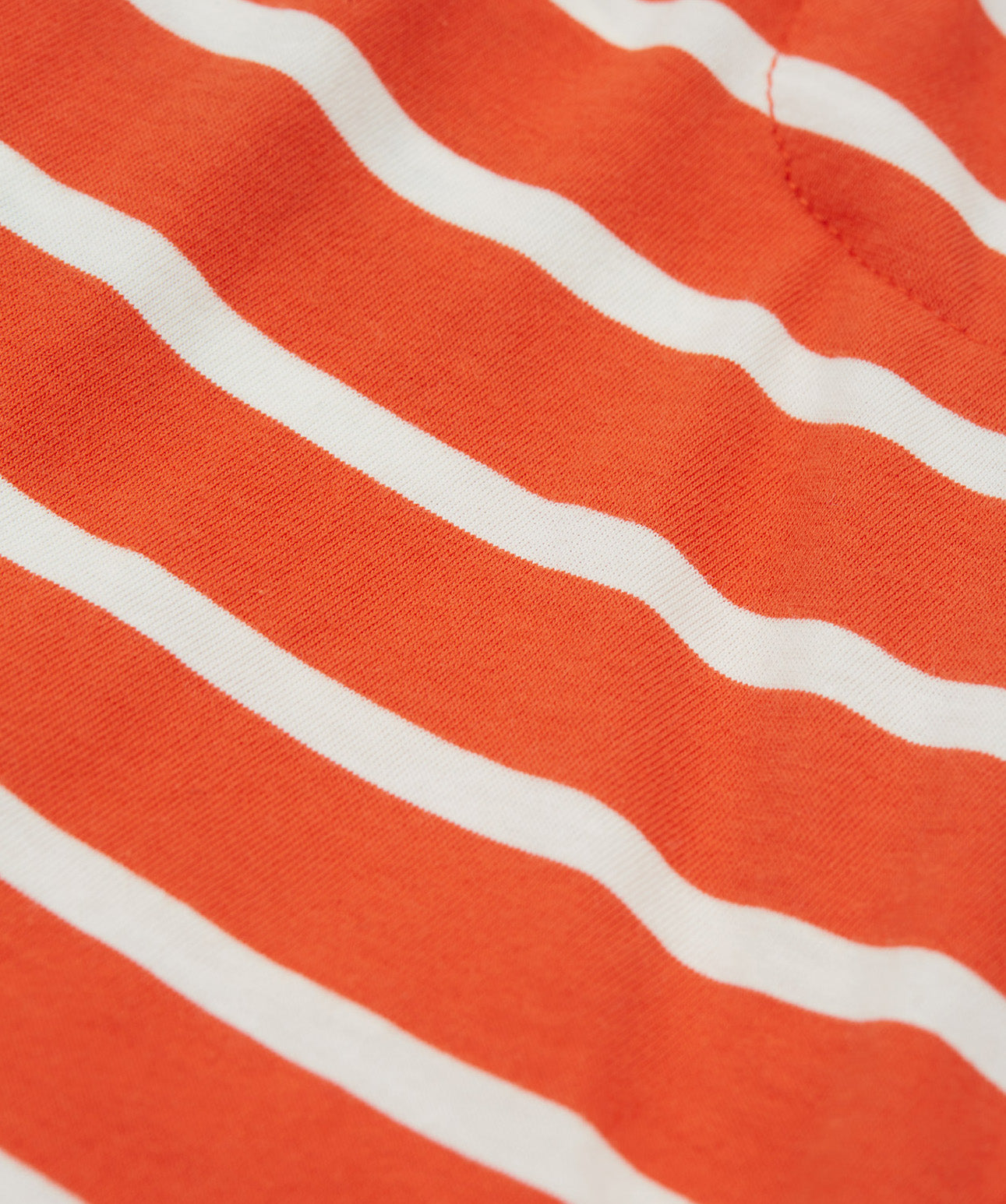 A close up of Frugi Stithian Shorts in Tiger Orange Breton.