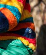 A close up of the small brand tag on the Frugi Autumn stripe ted stripe fleece stitched on the side.