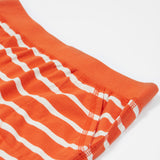 A close up of Frugi Stithian Shorts in Tiger Orange Breton's front pocket.