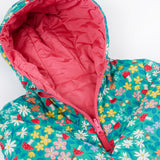 A close up of the Frugi toasty trail reversible jacket showing the playful woodland inspired design with pink zip and hood detail.