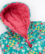 A close up of the Frugi toasty trail reversible jacket showing the playful woodland inspired design with pink zip and hood detail.