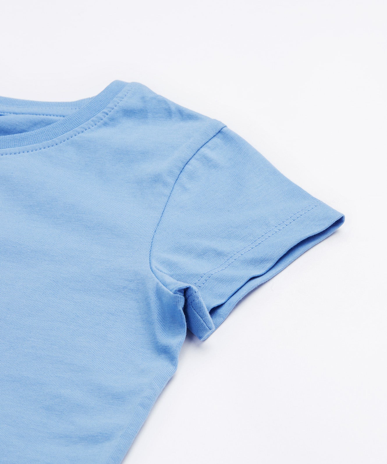 Close up of the Frugi kids cornflower blue, horse t-shirt. Showing the short sleeve detail on light blue organic cotton fabric.