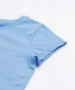 Close up of the Frugi kids cornflower blue, horse t-shirt. Showing the short sleeve detail on light blue organic cotton fabric.