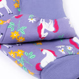 A close up of the fold-able cuffs on the Frugi Organic Cotton purple unicorn floral print Children's Big Snuggle Suit. This all in one snuggle suit is a part of a wide range of organic cotton clothing for children available here at Babipur.