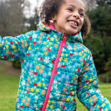 A child wearing the Frugi toasty trail reversible jacket showing the playful woodland inspired design with pink zip detail on post consumer recycled polyester fabric