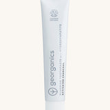 Front view of the Georganics activated charcoal hydroxyapatite toothpaste. A white tube with grey and black branding text.