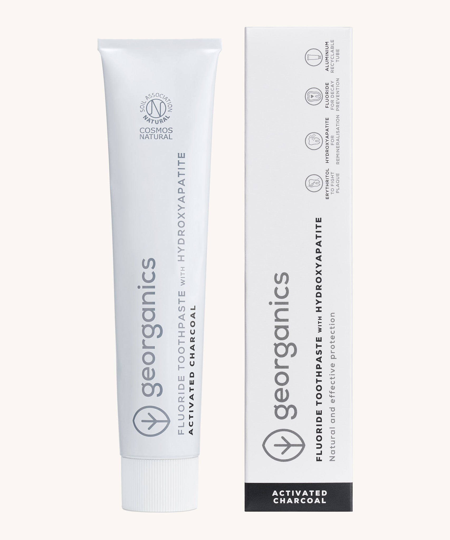 Front view of the Georganics activated charcoal hydroxyapatite toothpaste. A white tube with grey and black branding text next to matching cardboard packaging.