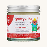 A jar of the kids strawberry fluoride toothpaste with a picture of a beaver on the jar on a cream background
