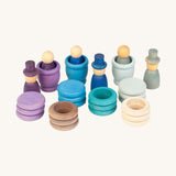 A wooden winter Grapat nin set including wooden cups rings and coins in matching winter colours on a cream background.