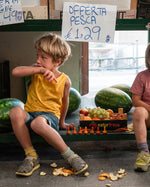 Close up of some Grapat plastic-free mandala pumpkin toys on a metal grate next to an orange vegetable