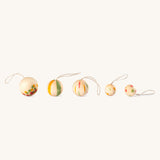 Multicoloured wooden Grapat in a line on a cream background