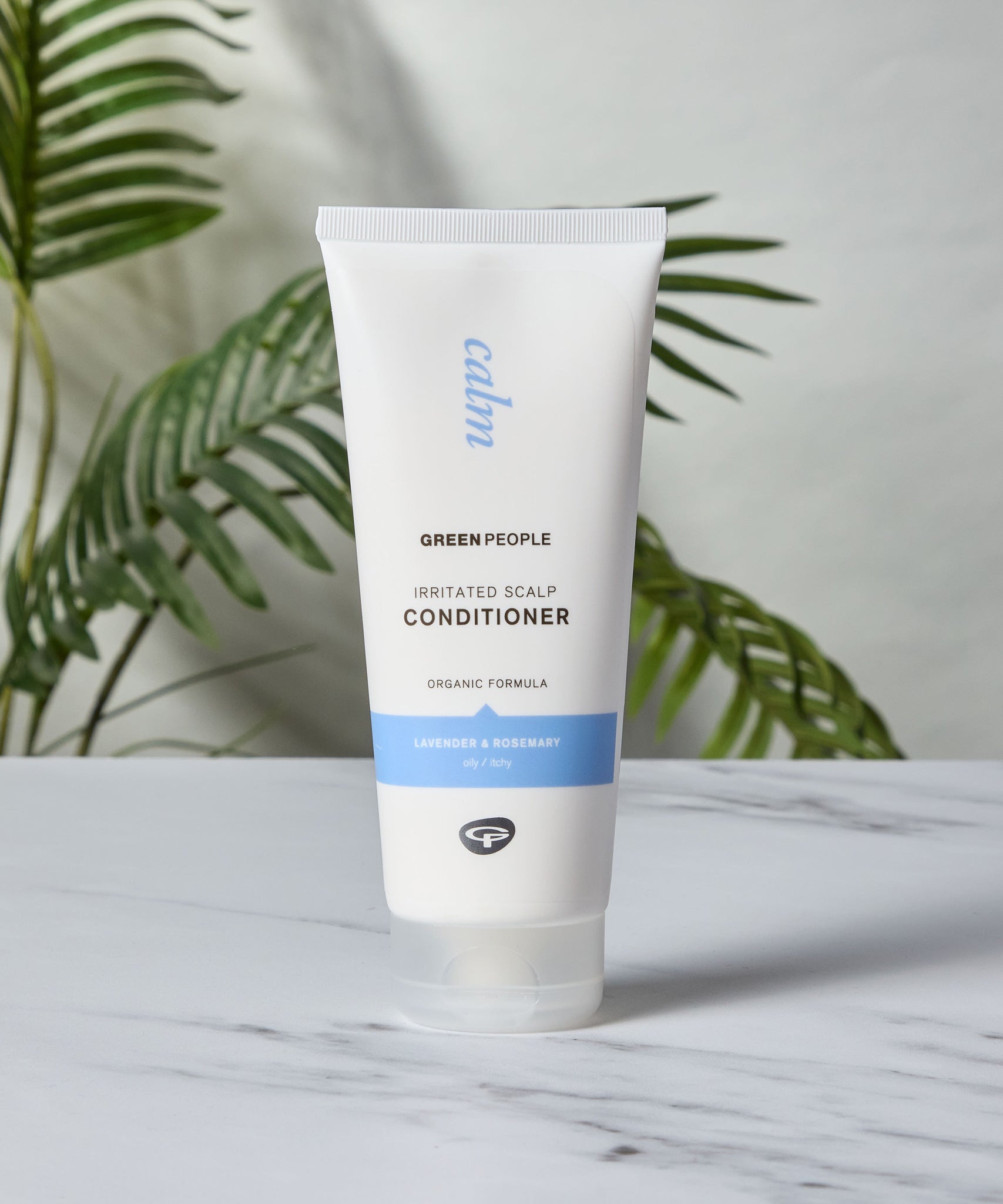 Green People Irritated Scalp Conditioner on a marble style surface.