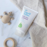 The Baby Wash & Shampoo bottle lying on top of a cream muslin cloth