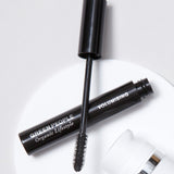 A close up of an open Green People Volumising Mascara showing the wand applicator brush.