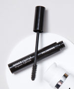 A close up of an open Green People Volumising Mascara showing the wand applicator brush.