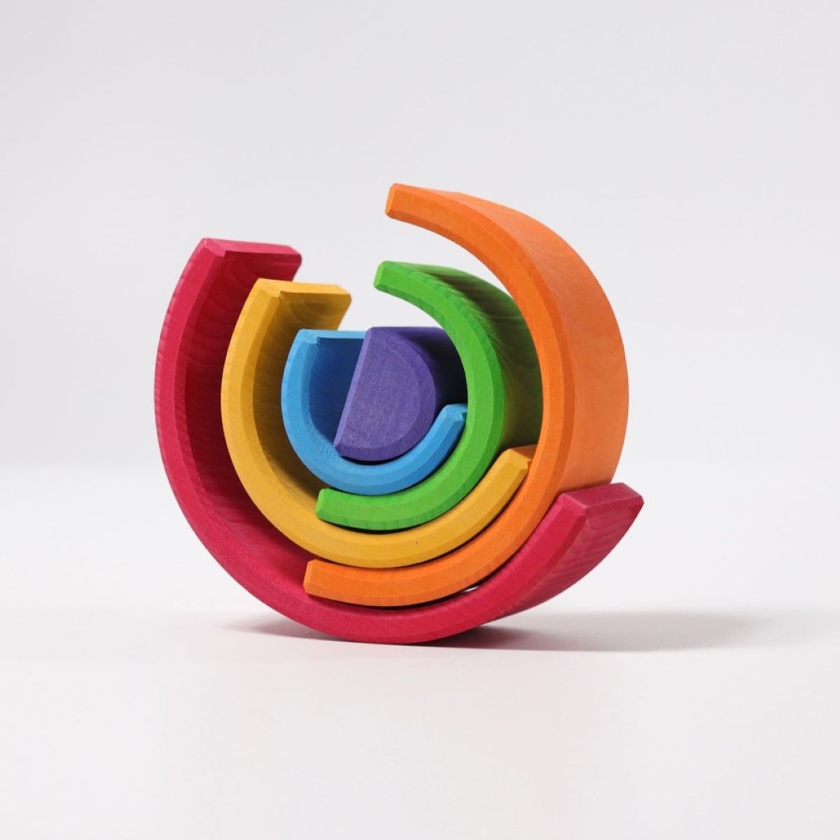 Grimm's Wooden Medium Rainbow stack on a grey background