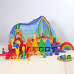 Grimm's Wooden Medium Rainbow outside with a woodland background
