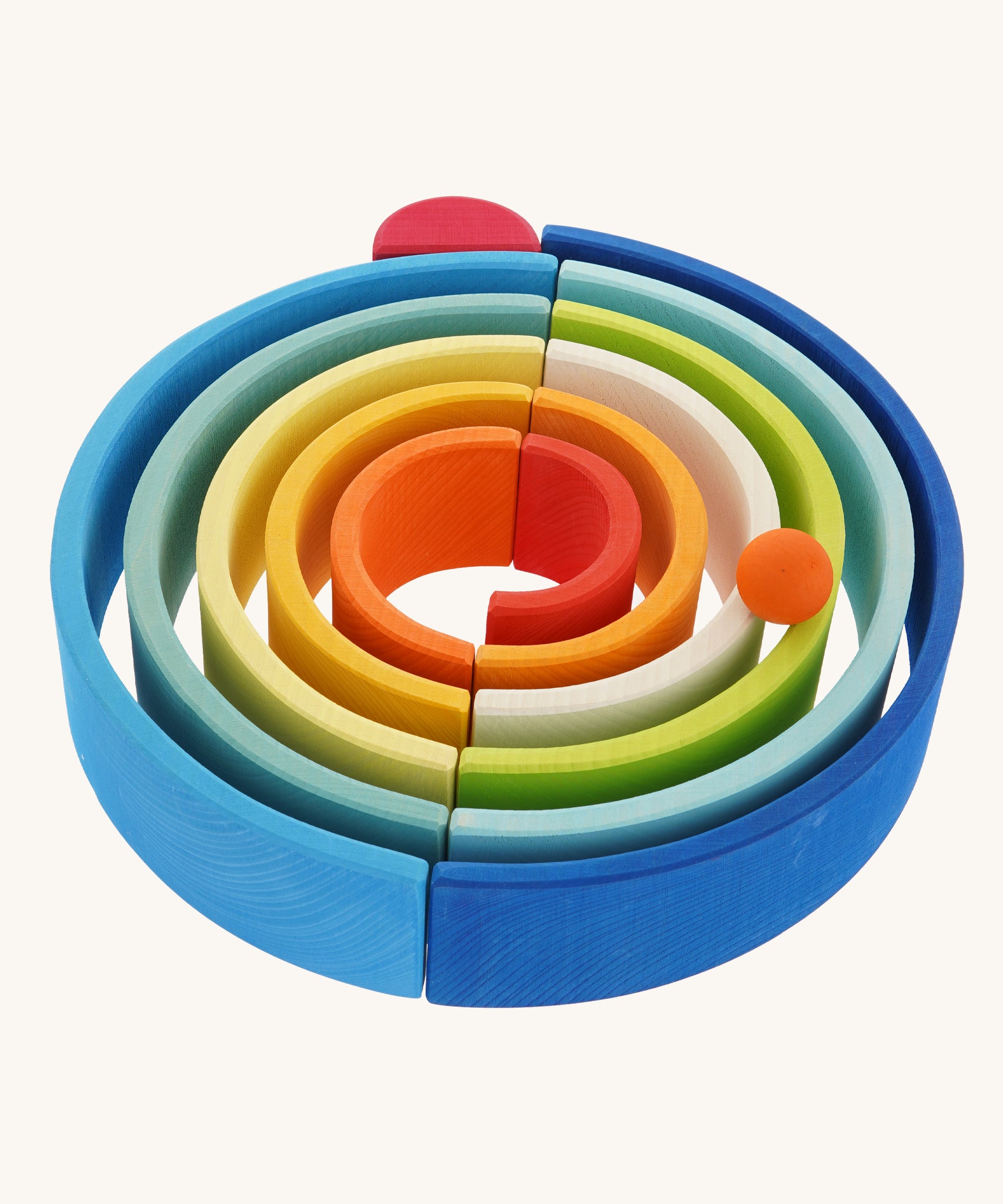 The Grimm's Gwawr Sunrise 12 Piece Rainbow on a plain background.  The pieces have been laid out to create a circular shaped ball run.