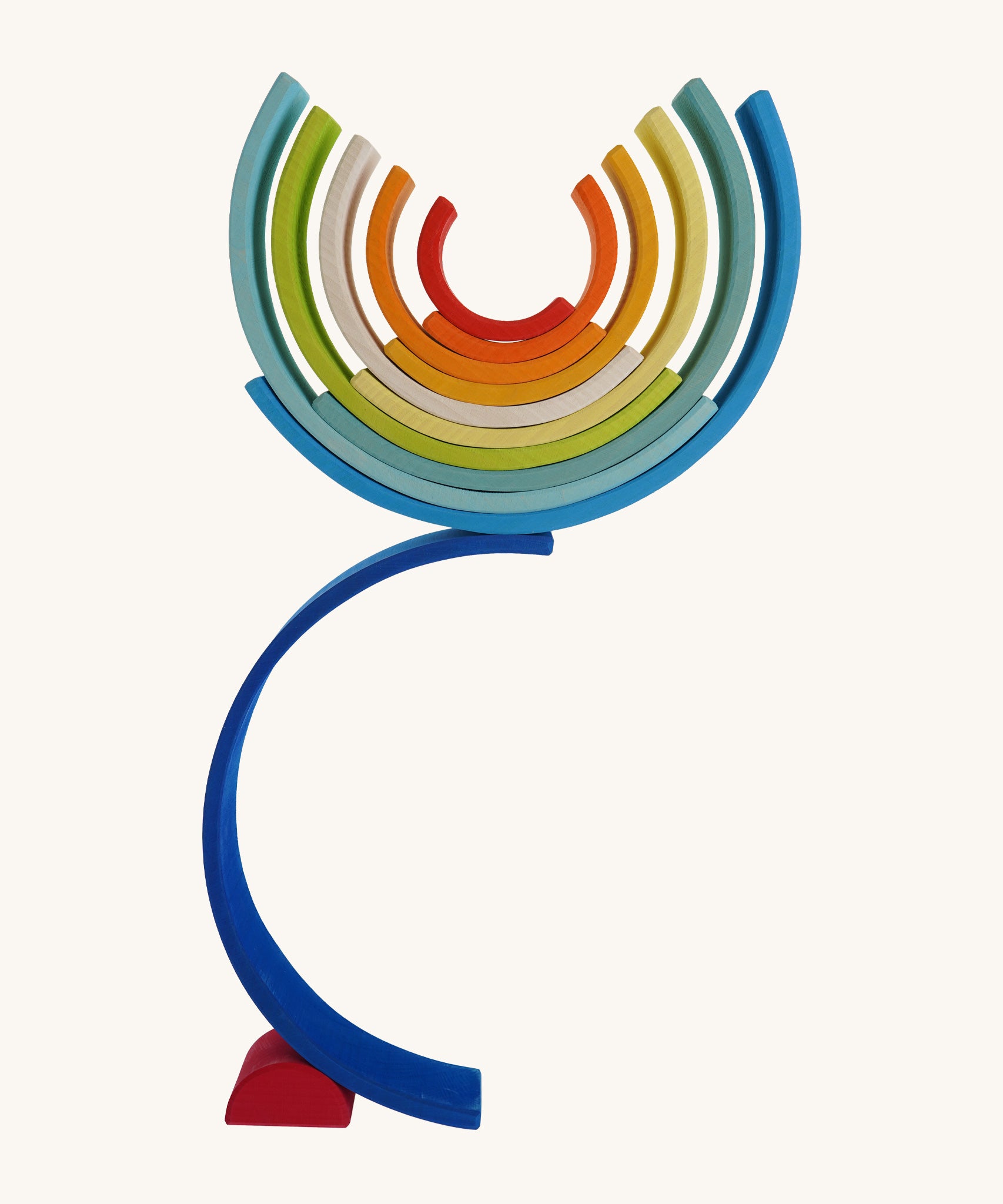 The Grimm's Gwawr Sunrise 12 Piece Rainbow on a plain background.  The pieces have been used to create a tall balancing stack.