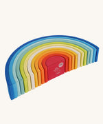 The Grimm's Gwawr Sunrise 12 Piece Rainbow on a plain background. The rainbow has been placed on it's side showing the Grimm's Babipur logo undeeneath on the red piece.