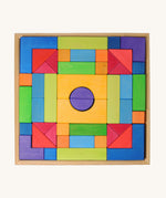 Grimm's wooden Blocks Basic Building Set 2. A set of colourful wooden toy building blocks in a wooden storage tray. The blocks are varous sizes and shapes inlcuding cubes, half cylinders, arches, triangles and more.