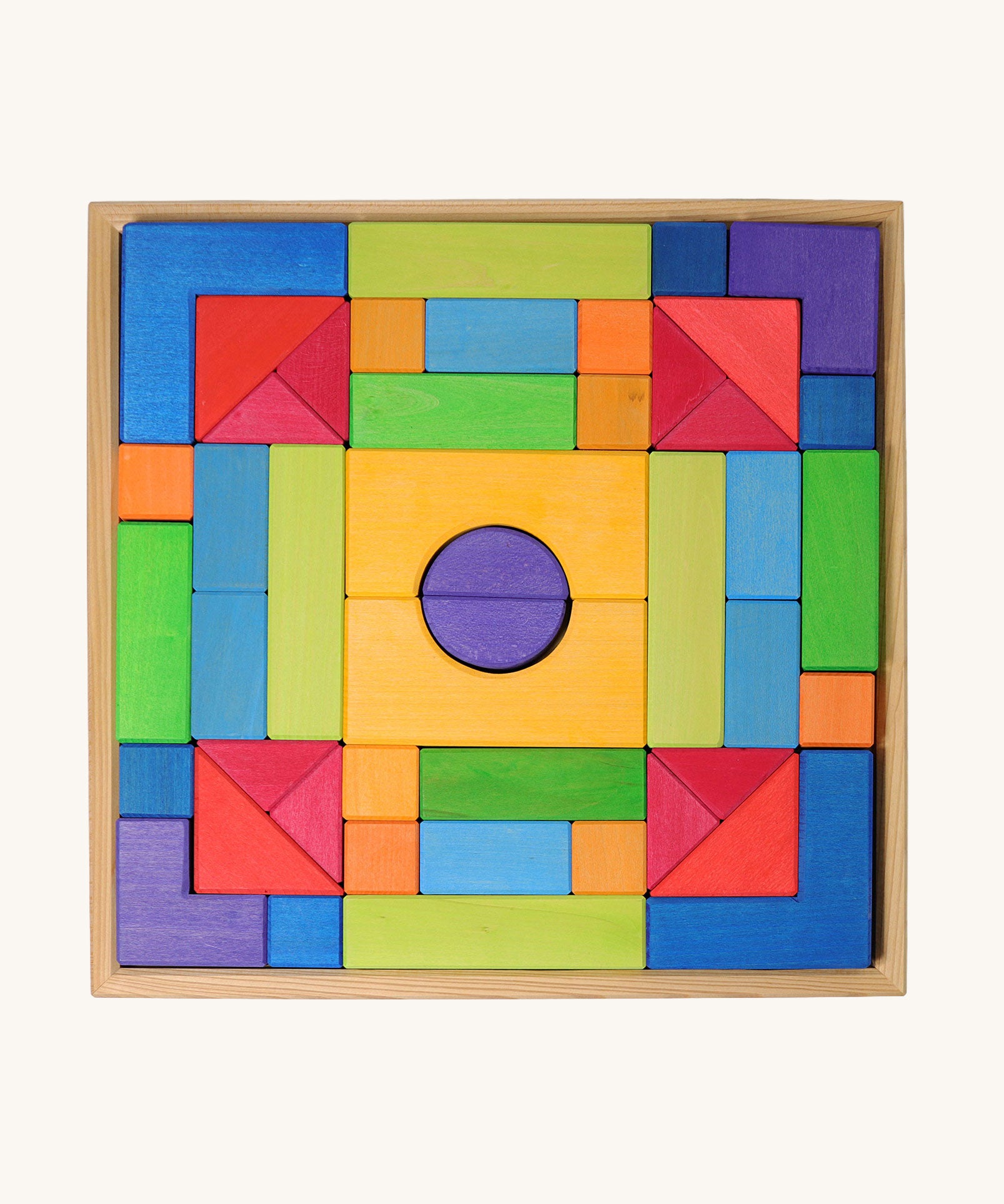 Grimm's wooden Blocks Basic Building Set 2. A set of colourful wooden toy building blocks in a wooden storage tray. The blocks are varous sizes and shapes inlcuding cubes, half cylinders, arches, triangles and more.