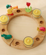 A celebration ring with the Grimm's beeswax candles and tealight holders.