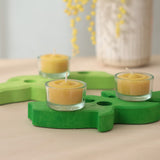 Grimm's beeswax tealights in glass holders, on a green wooden celebration spiral