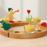 A celebration ring with Grimm's celebration figures and 100% beeswax tealights.