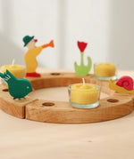 A celebration ring with Grimm's celebration figures and 100% beeswax tealights.