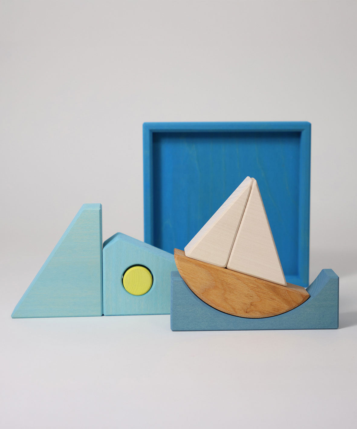 The blocks from the Grimm's blue building set taken out of the wooden storage tray. These Grimm's wooden block sets are part of a wide range of wooden toys available here at Babipur.