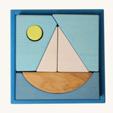 Grimm's Building Set Blue. A set of wooden blocks that form a sailing boat when placed in the blue coloured storage tray. These Grimm's toys are part of a wide range of wooden toys available here at Babipur.