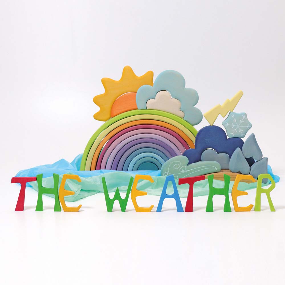 The Grimm's Wooden Weather Building Set set up along side the 12 piece pastel rainbow and free standing letters.
