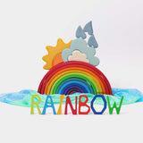 The Grimm's Wooden Weather Building Set set up along side the 12 piece rainbow and free standing letters.