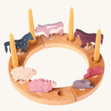 A natural Grimm's celebration figure decoreated with wooden figures and candles. These Waldorf inspired decorative figures are part of a wide range of wooden decorations for celebration rings available here at Babipur.