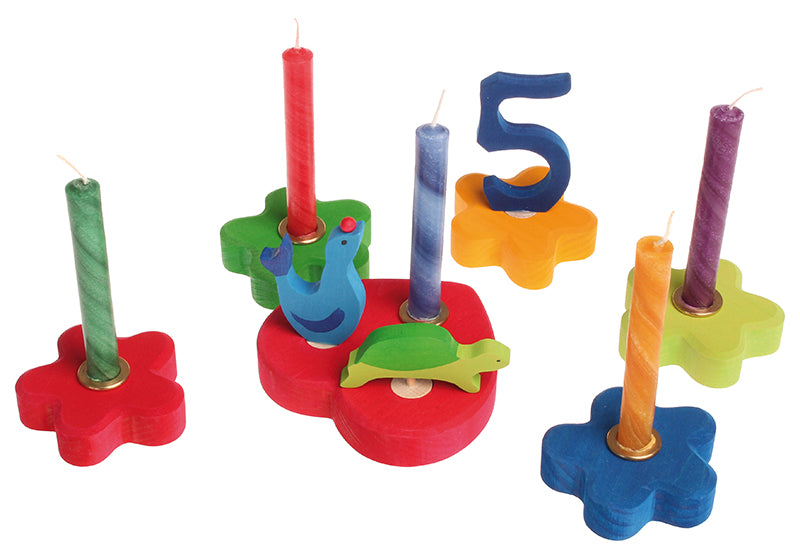 A collection of Grimm's celebration ring pieces, candles and decorative figures. These Waldorf inspired decorative figures are part of a wide range of wooden decorations for celebration rings available here at Babipur.