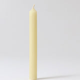 A close up of a single Grimms 100% beeswax candle showing the wick detail