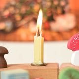 A cream coloured 100% beeswax candle from Grimm's designed to fit in the holders for the celebration rings. The candle has been lit