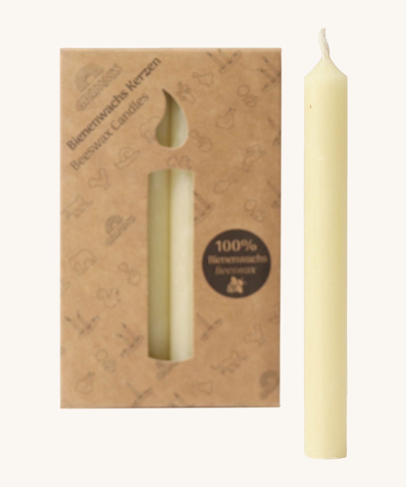 A close up of the Grimms 100% beeswax candles in cream with the cardboard packaging in the background.
