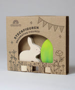 Grimm's Easter Decorative Figure Set featuring a white bunny rabbit a Batik Green coloured eggs. The figures are shown in their cardboard packaging