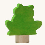 A back view of the Grimms green frog wooden decorative figure showing the small base stand detail