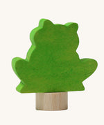A back view of the Grimms green frog wooden decorative figure showing the small base stand detail