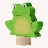 A side view of the Grimms green frog wooden decorative figure showing the thickness of the figure