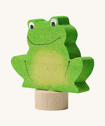 A side view of the Grimms green frog wooden decorative figure showing the thickness of the figure