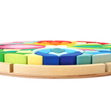 Grimm's Lara Waldorf toy blocks in their round base on a white background