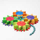 The triangluar shaped blocks from the Grimm's Octagon Puzzles used to created flower shapes withe the large set used for the flowers and the smaller sets used for the stems and details.