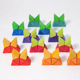 The triangle shaped blocks from the Grimm's Large Octagon Puzzle stacked up .