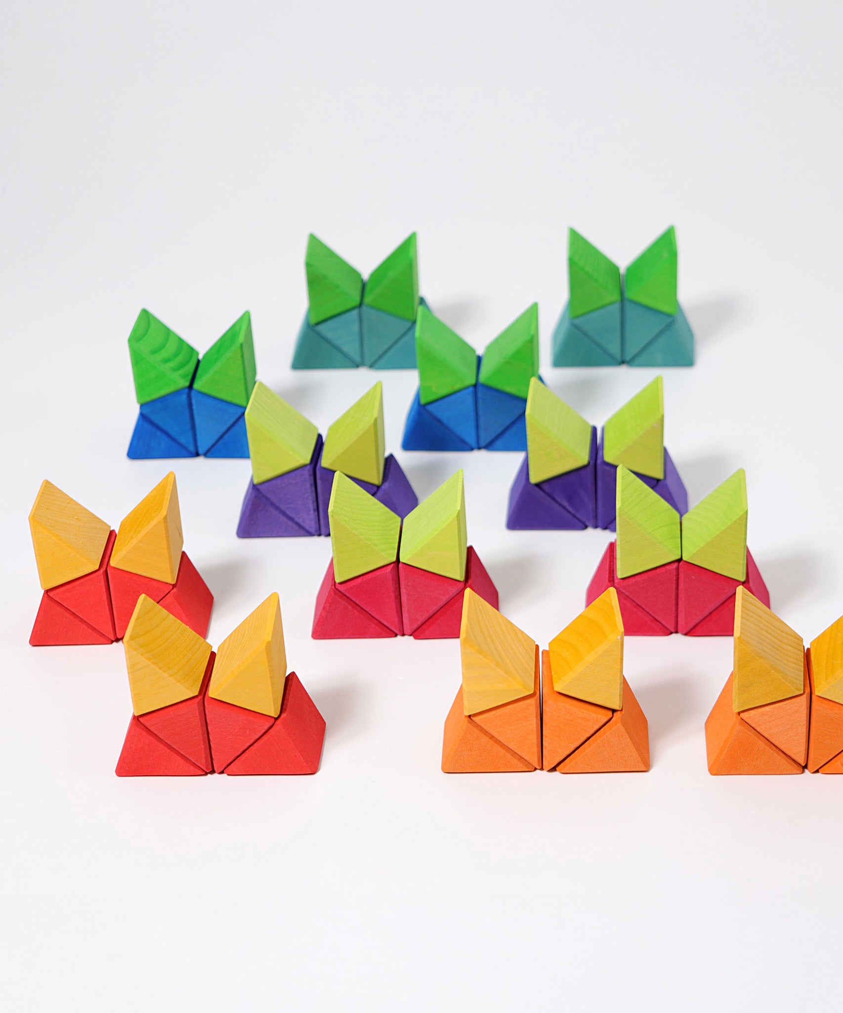 The triangle shaped blocks from the Grimm's Large Octagon Puzzle stacked up .