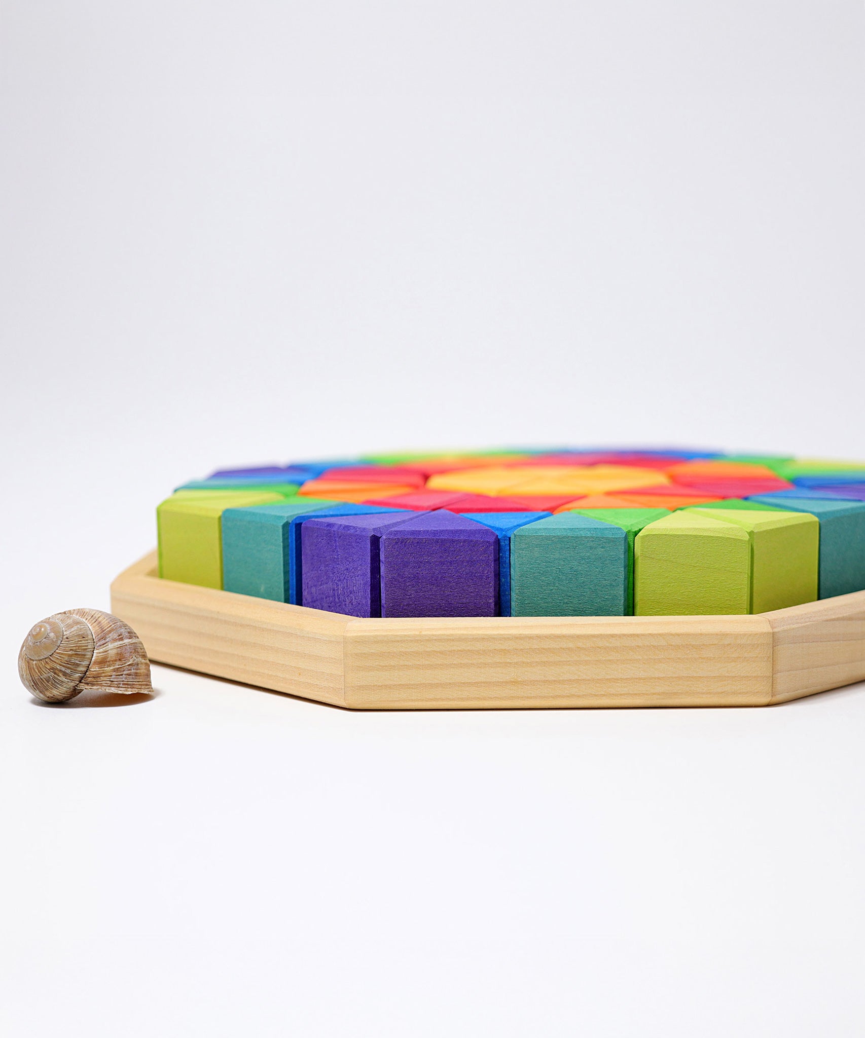 A side view of the tray containing The triangluar shaped blocks from the Grimm's Octagon Puzzles.